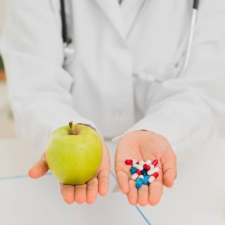 Doctor holding green apple pills