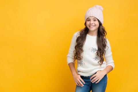 Smiling girl sweater with snowflakes