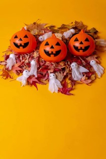 Overhead view of orange Halloween pumpkins on a background of yellow