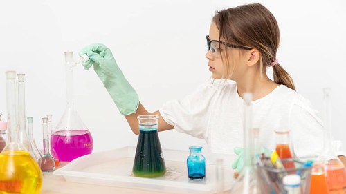 Side view girl doing chemistry experiments