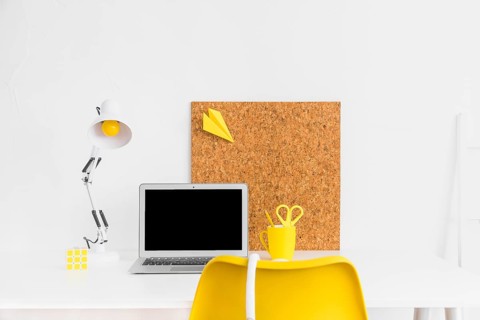 Stylish workspace yellow white colors with cork board