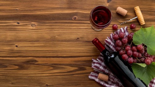Top view wine bottle with glass wooden background