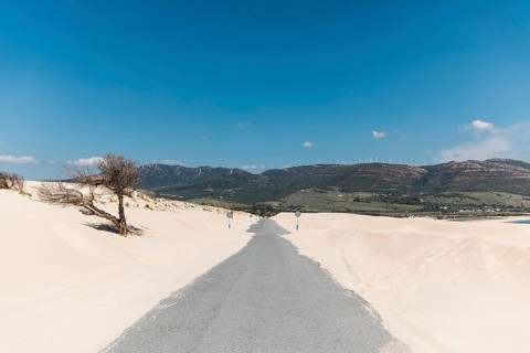 Empty road sands against mountains
