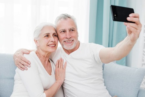 Elder couple making selfie