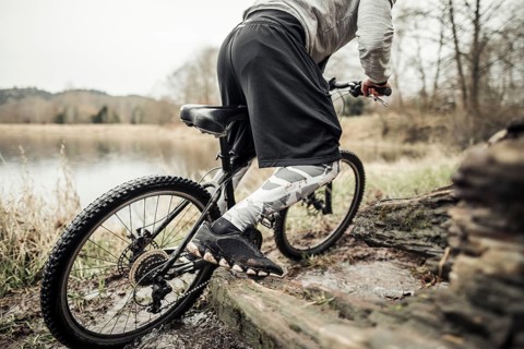 Cyclist riding bike near lake