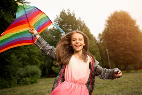 Front view beautiful happy girl with kite