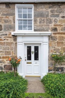 White front door on an old stone house