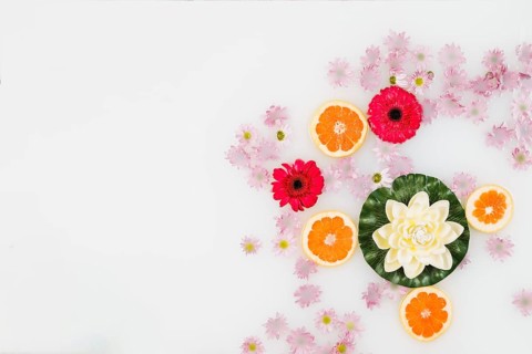 High angle view bath milk decorated with grapefruit slices various flowers