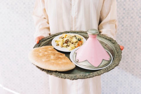 Muslim man holding plate food