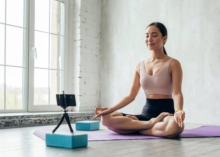 Young woman showing meditation technique new vlog