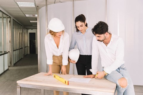 Group engineers leaning table
