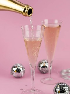 Champagne pouring glass from golden bottle