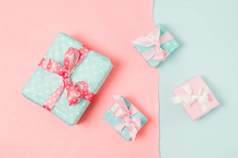 Small big decorated gift boxed tied with ribbon arrange peach blue wallpaper