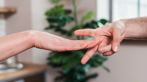 Close up couple playing rock paper scissors game