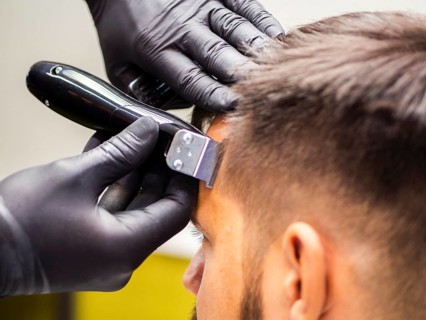 Close up hairdresser hands with gloves