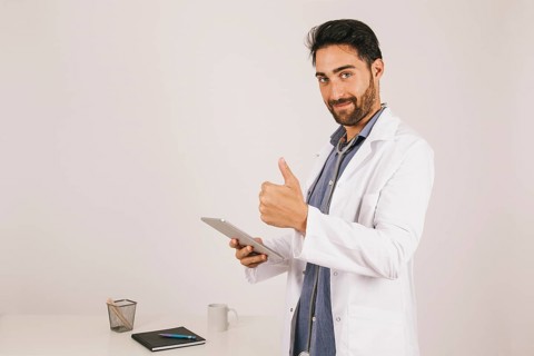 Doctor with ipad thumb up