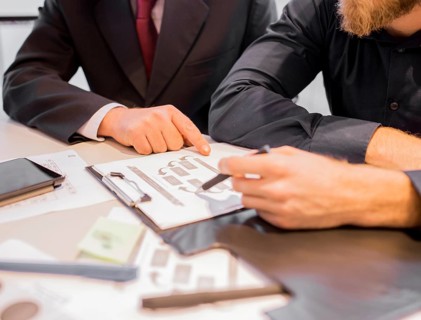 Close up two businessmen pointing business chart meeting
