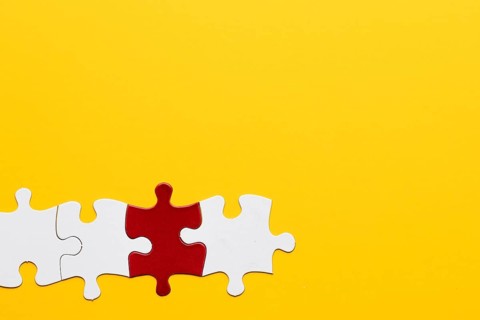 Red white puzzle piece with yellow background