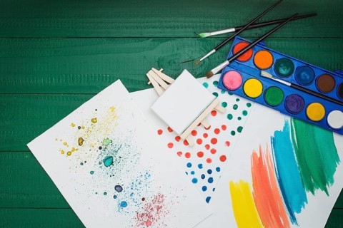 Watercolor stained brushstroke white sheet with mini easel watercolor palette