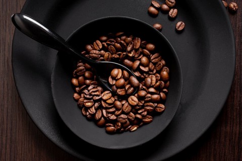 Roasted coffee beans bowl with spoon