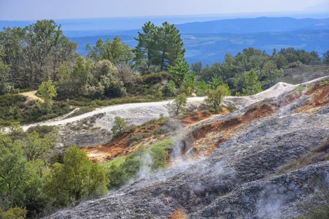 Steam rises from colourful rubble heaps
