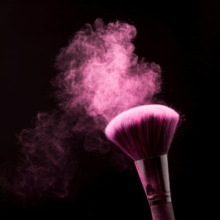 Bright dust powder brush makeup black background