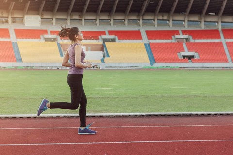 Girl running athletic track