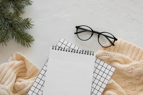 Top view stationery empty papers with reading glasses