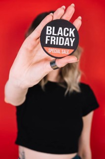 Close up woman hand with black friday sign