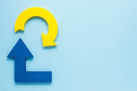 Flat lay blue yellow arrows blue background with copy space