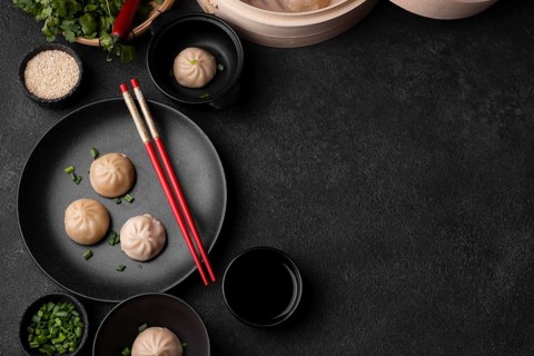 Top view asian dumplings with chopsticks copy space