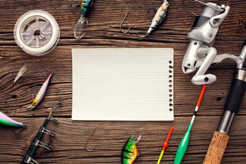 Top view fishing essentials with sheet paper bait