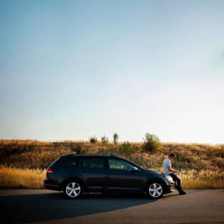 Man sitting car hood
