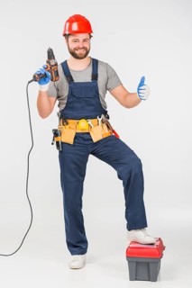 Repairman with drill showing thumb up
