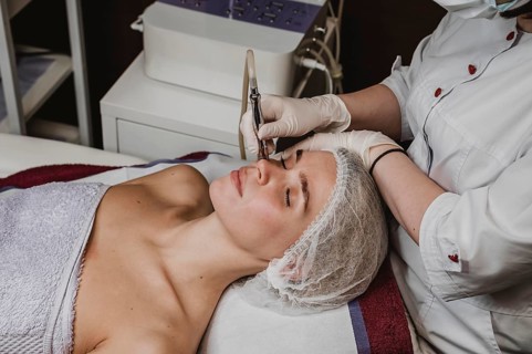Young woman wellness center having cosmetic treatment
