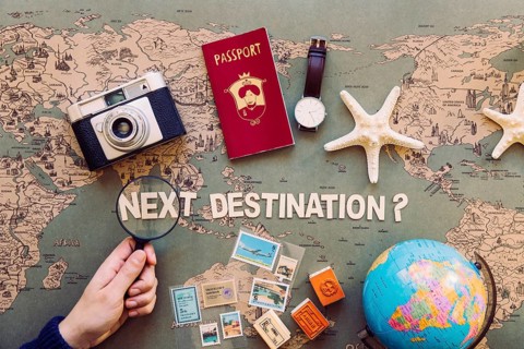 Hand holding magnifier destination writing