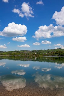 (Cumulus) clouds reflected in the Irrsee, Zell am moss, Salzkammergut, Upper Austria, Austria,