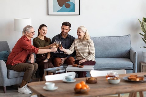 Medium shot happy family clinking glasses