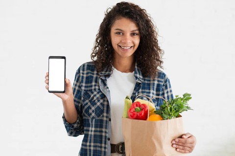 Woman holding vegetables bag phone mock up