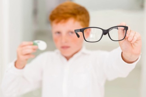 Close up boy showing black frame eyeglasses