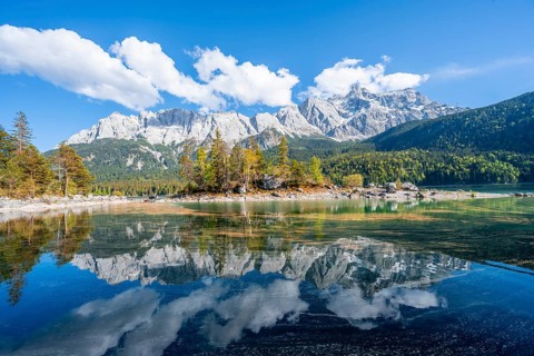 Zugspitze massif and Zugspitze reflected in Eibsee lake