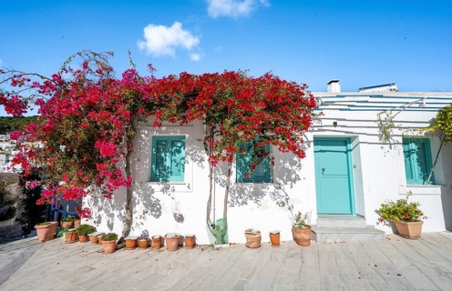 White Cycladic house with turquoise windows and doors