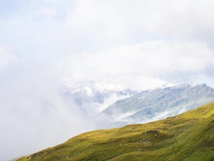 Morning fog drifts over a mountain ridge