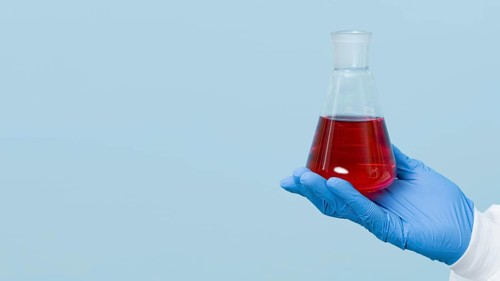 Front view scientist holding red chemical with copy space