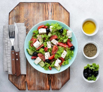 Top view salad with feta cheese cutting board with olives