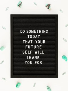 Black motivational text board flat lay
