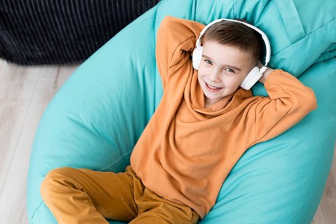 Smiley kid sitting bean bag chair