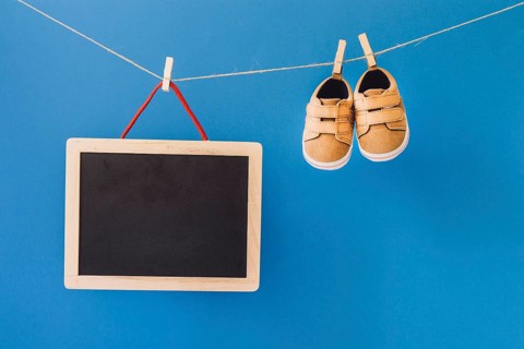 Baby concept with slate shoes clothesline