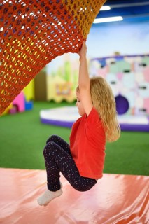 Girl climbing playground side view