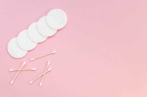 Flat lay arrangement with cotton pads ear sticks